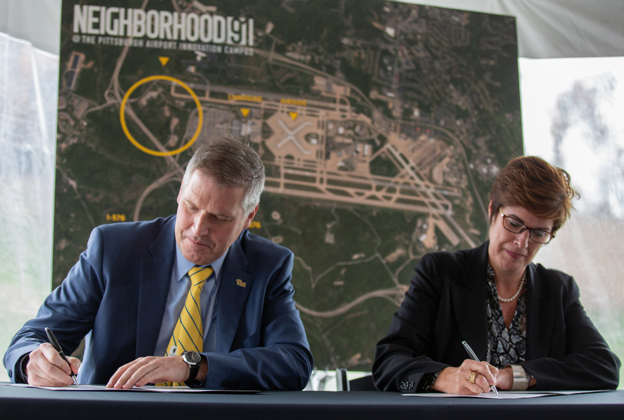 Chancellor Gallagher and Christina Cassotis, CEO of Pittsburgh International, sign agreement
