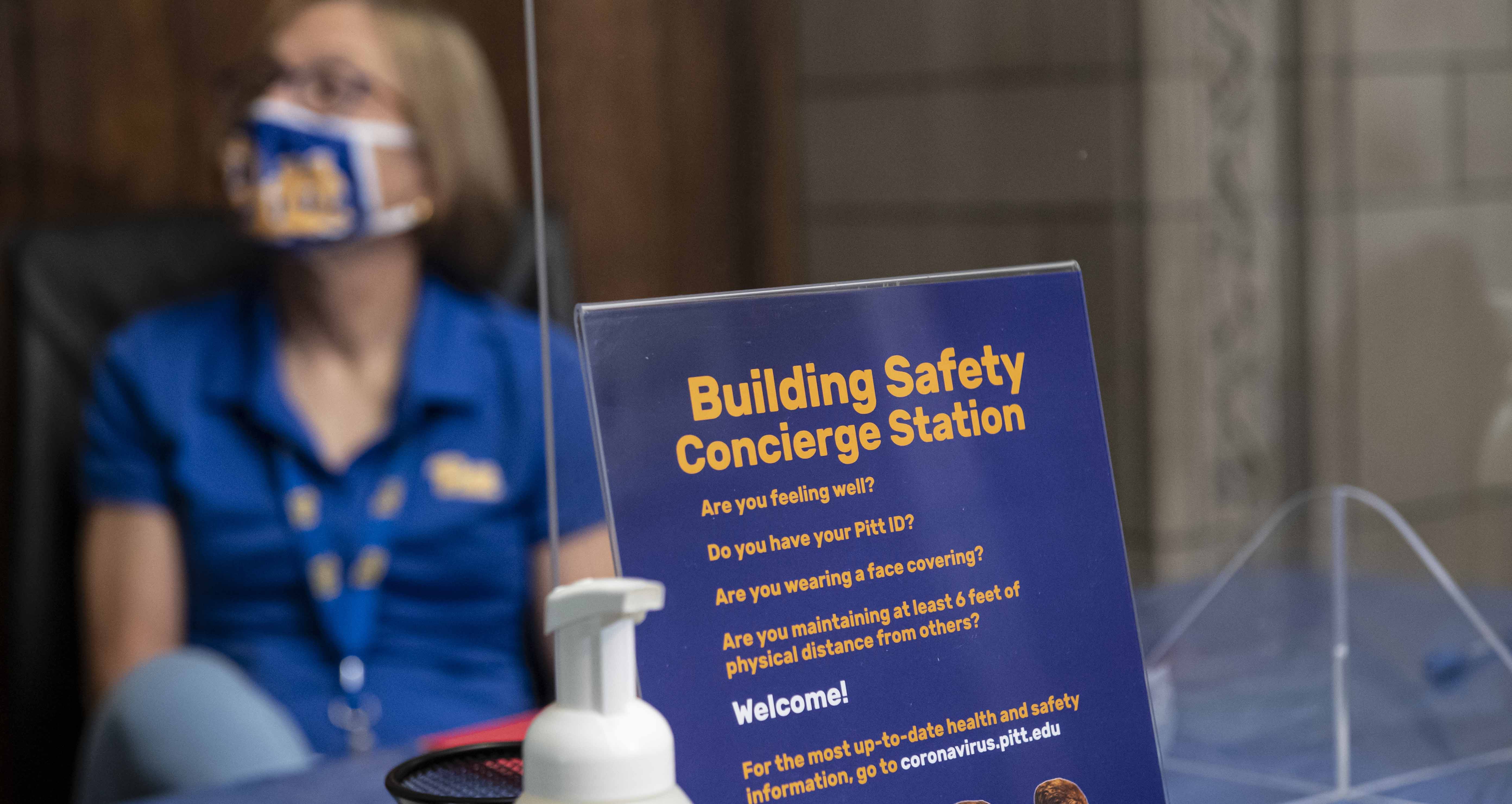 Sign about building safety rules with blurred person in background