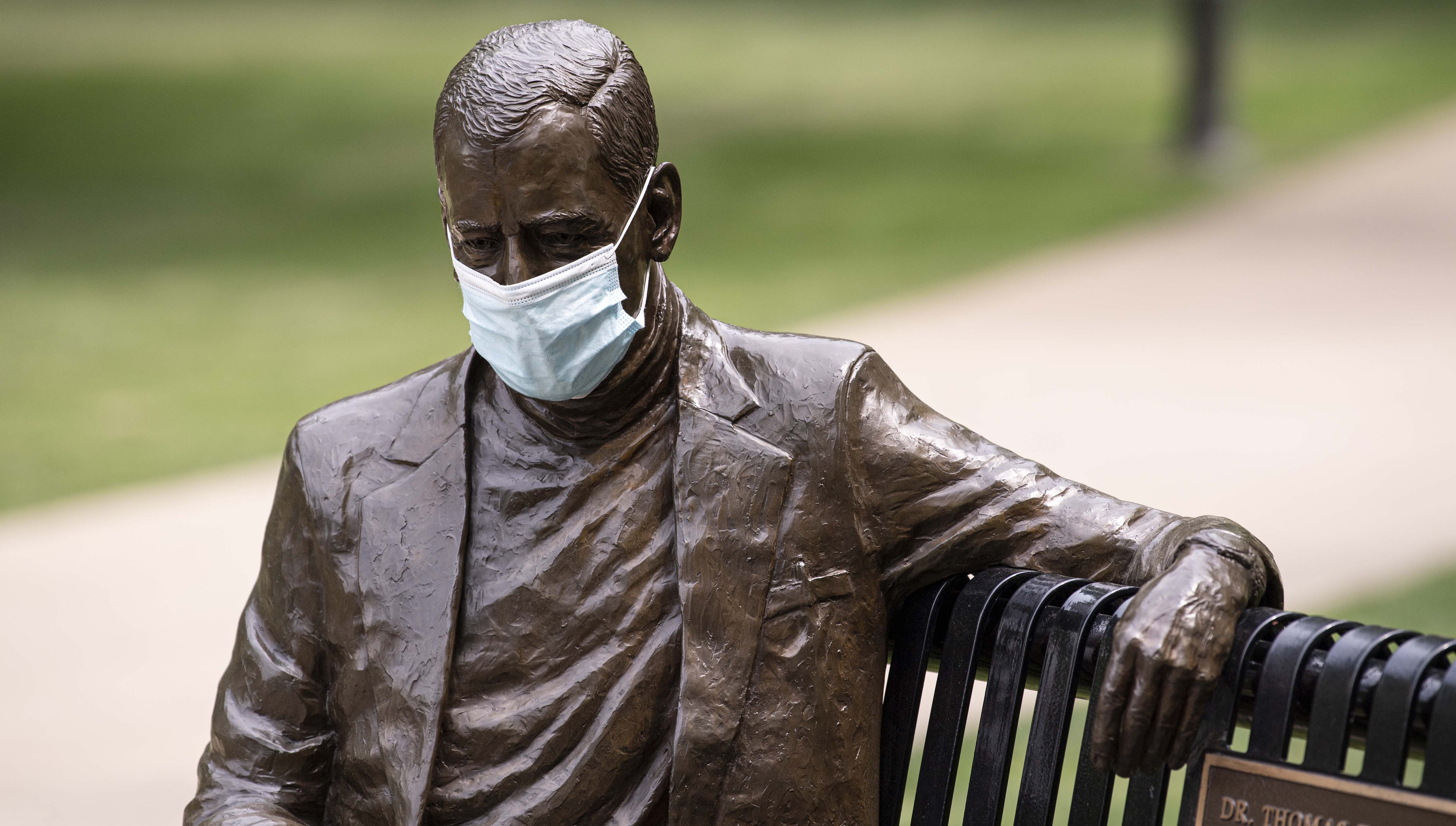 Statue of Thomas Starzl with face mask