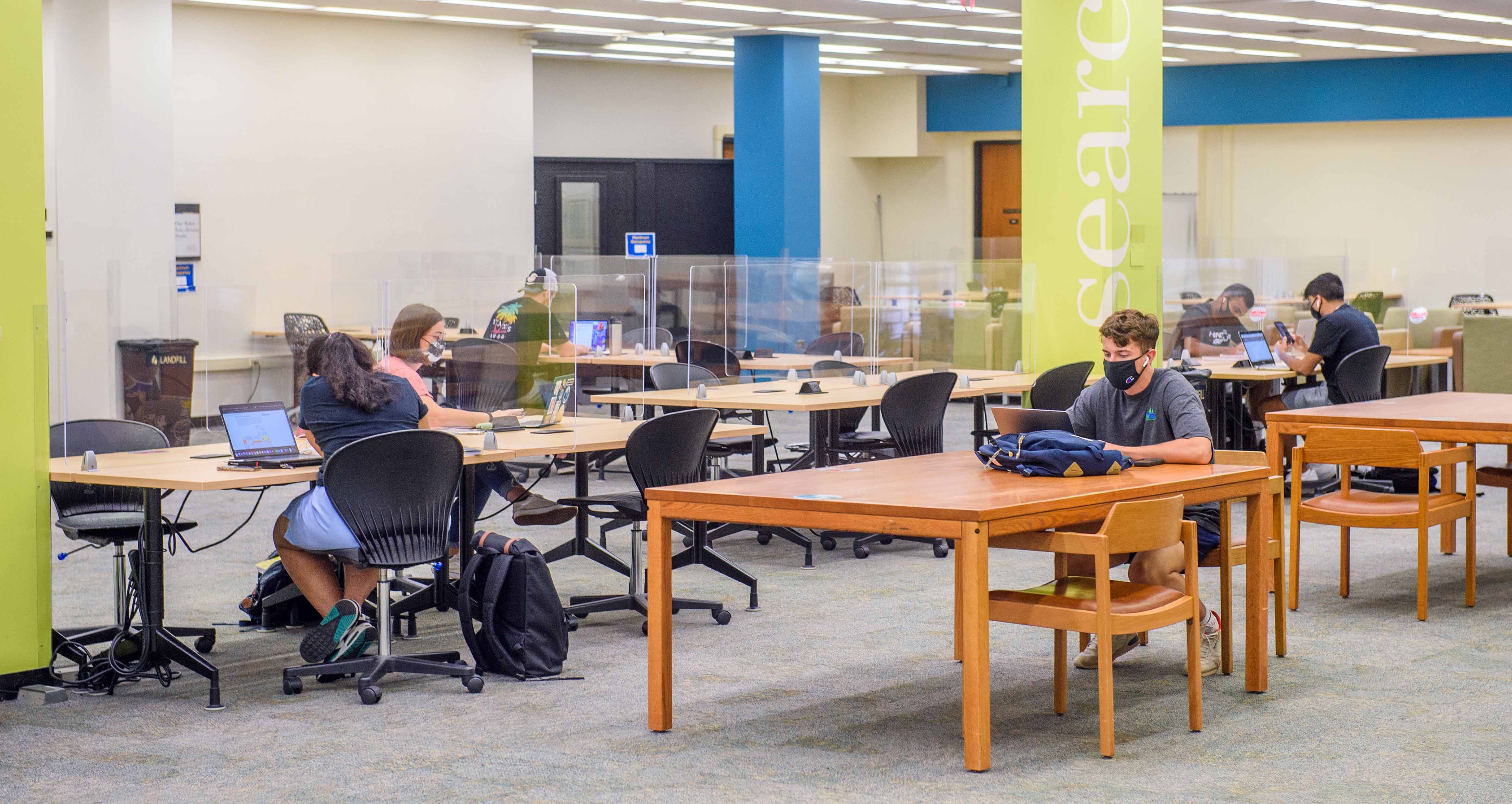 tables and students on ground floor of Hillman Library